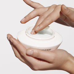 Applying Kerastase Nutritive Rich Hair Mask from a white jar for deep hair nourishment