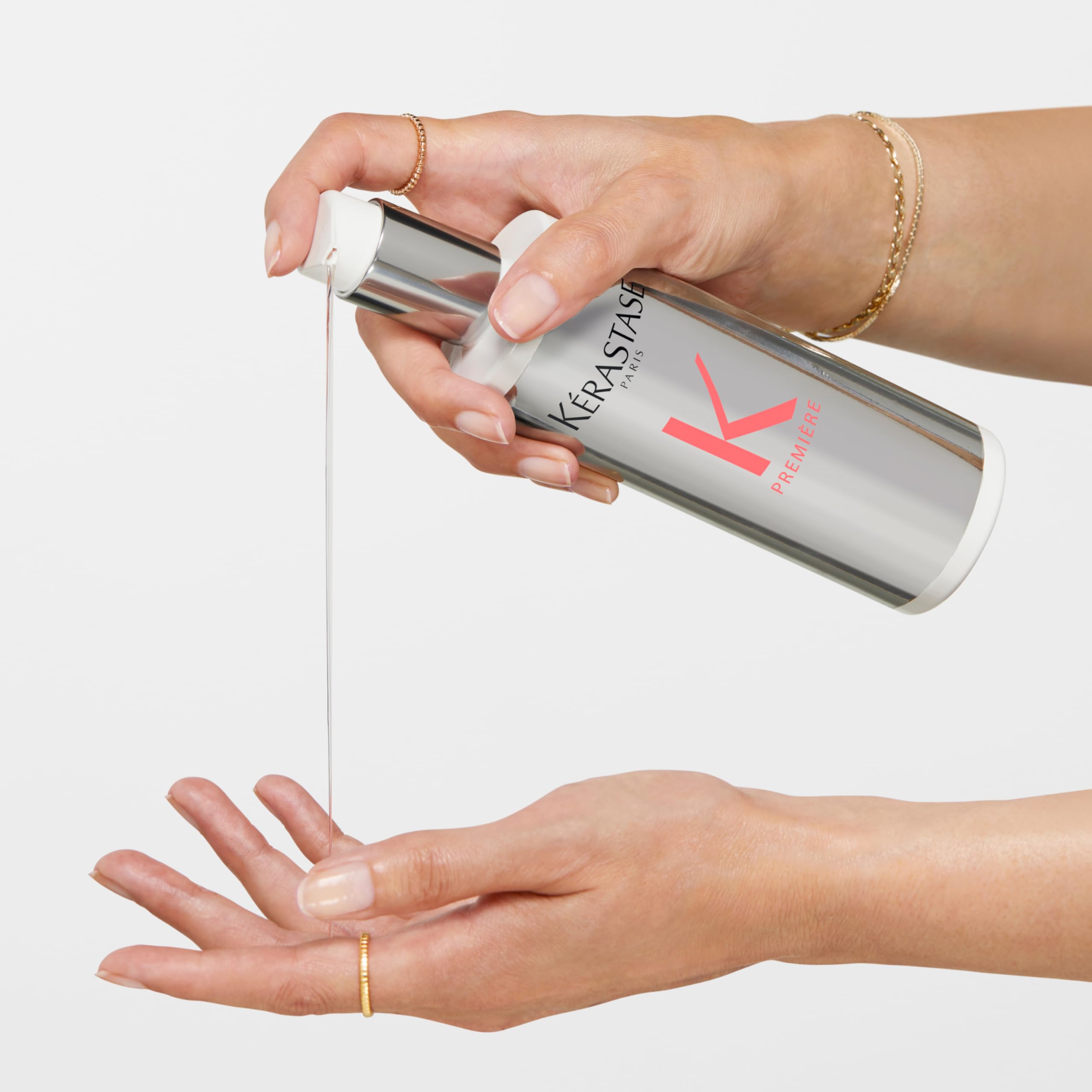 Kerastase Premier Decalcifen shampoo being dispensed into a hand for hair care routine