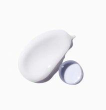White cream smear with small open cap container for hair repair mask product
