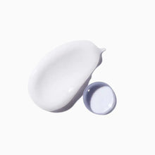 White cream swatch with small open cap container for hair repair mask product