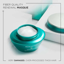 Turquoise hair mask jar with white cream scoop, Kérastase Resistance Therapist