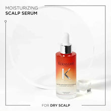Kérastase moisturizing scalp serum bottle with silver dropper, orange serum