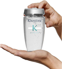 Keratase Anti-Dandruff Shampoo UAE in a sleek bottle held in a hand for clear visibility