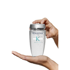 Keratase Anti-Dandruff Shampoo UAE in a sleek bottle held in a hand, designed for effective scalp care