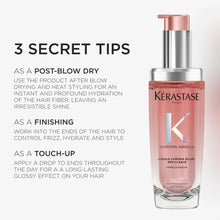 Refillable hair oil bottle with rose-pink liquid and silver pump top, side front view