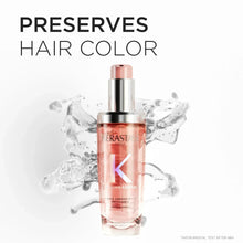 Refillable hair oil bottle with rose-pink liquid and silver pump top, front view
