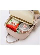 Light beige baby travel bag open to inner compartments with bottle pockets