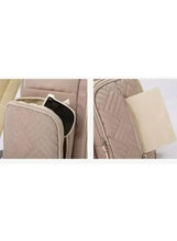 Light beige baby travel bag showing interior pockets and zip compartments