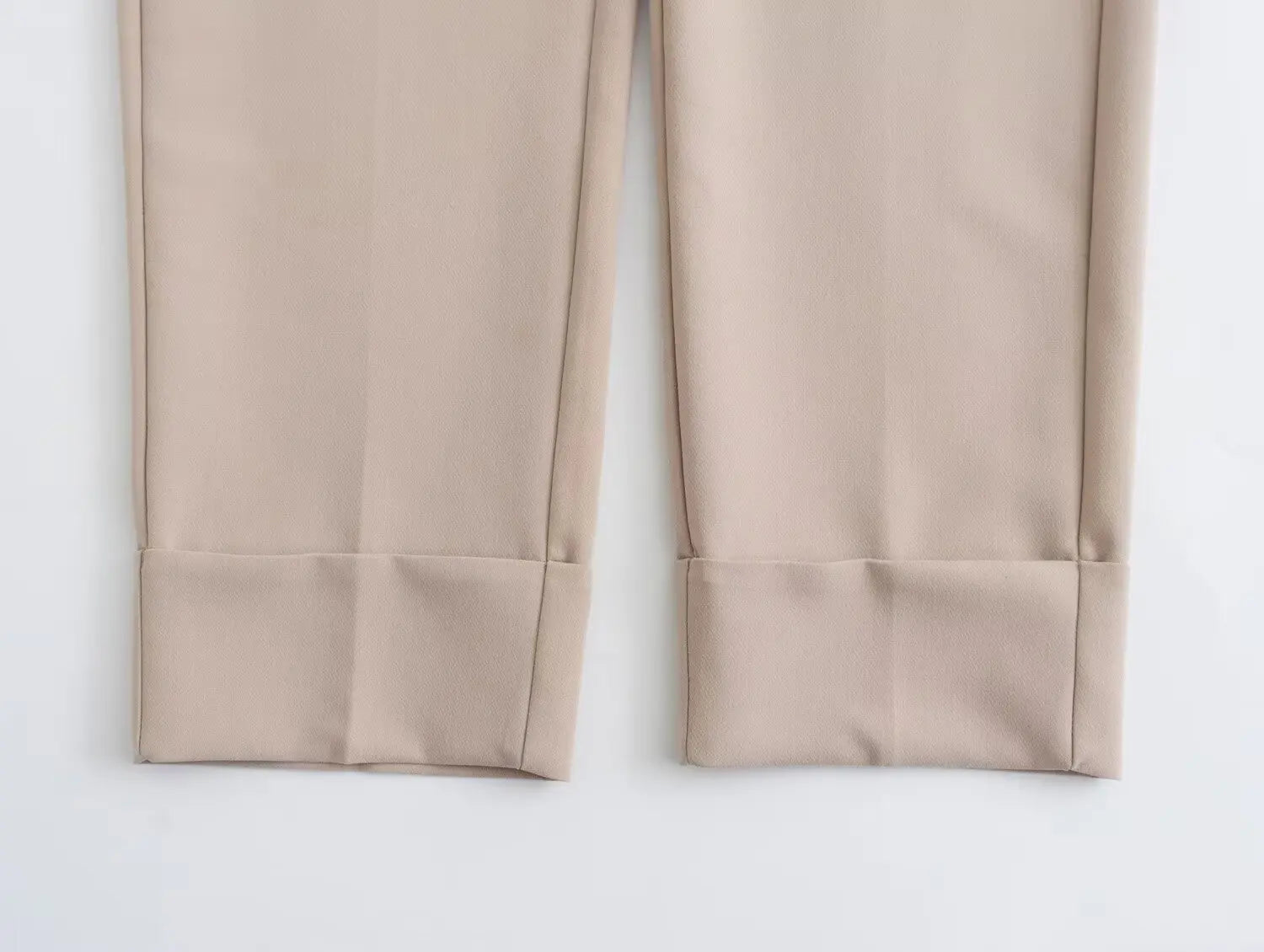 Close-up of khaki women's suit set pants featuring tailored cuffs for a polished look