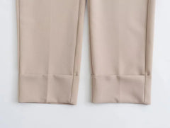 Close-up of khaki women's suit set pants featuring tailored cuffs for a polished look