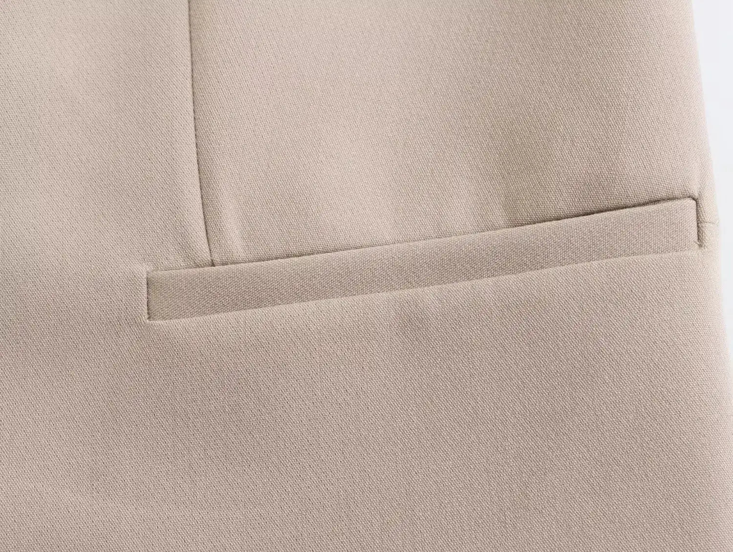 Close-up of a pocket detail on a khaki women's suit set highlighting quality fabric and design