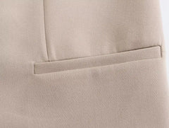 Close-up of a pocket detail on a khaki women's suit set highlighting quality fabric and design