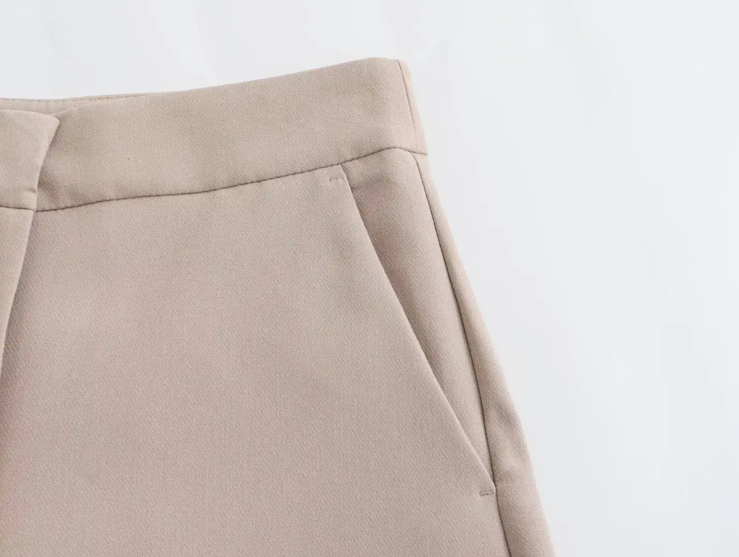 Close-up of Khaki women's suit set pants featuring stylish pockets and a tailored fit
