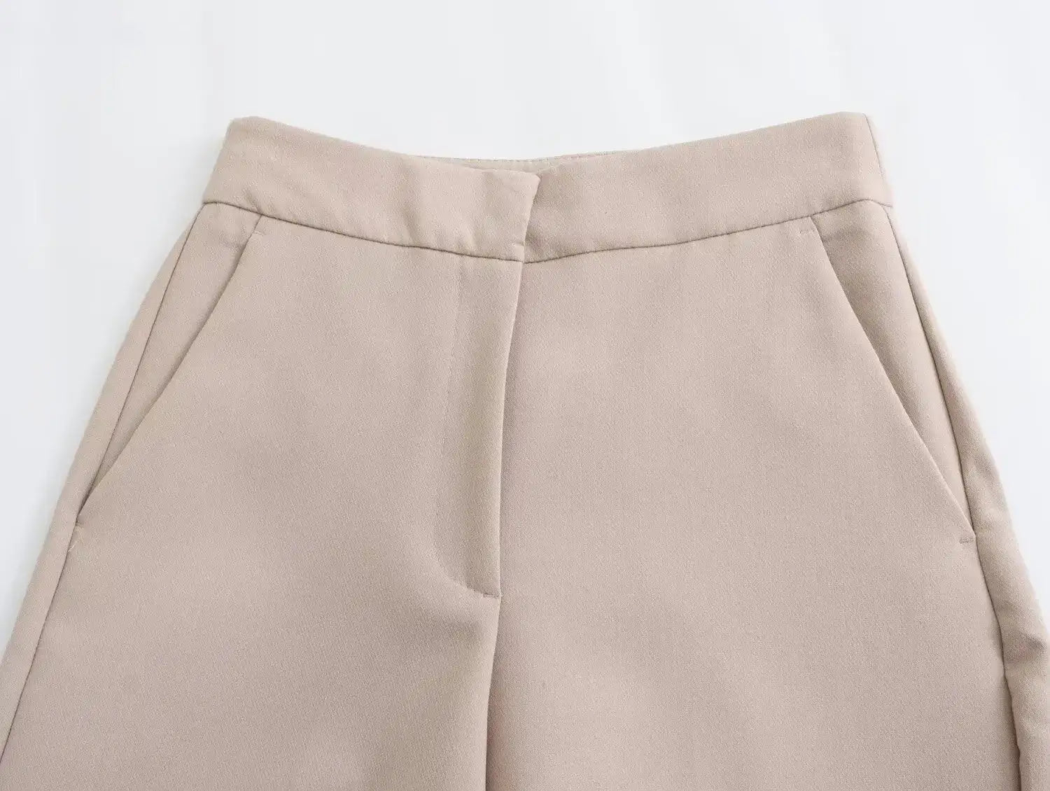 Close-up of khaki women's suit set pants featuring side pockets and a tailored fit