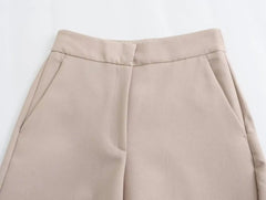 Close-up of khaki women's suit set pants featuring side pockets and a tailored fit