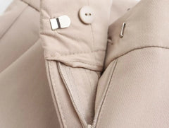 Close-up of khaki women's suit set with detailed stitching and secure fastenings