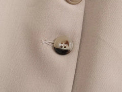 Close-up of a khaki women's suit set featuring a stylish button detail