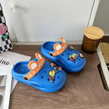 Blue kids cartoon clogs with orange strap and vehicle patch, open-back design