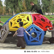 Kids dome climber close-up with yellow, red, and blue panels on outdoor ground