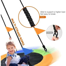 Round hammock swing with braided black ropes and orange-green padded ring seat
