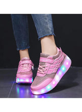 Kids pink LED roller skate shoes on feet with glowing light-up wheels