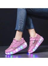 Kids pink LED roller skate shoes with light-up wheels on a child's feet