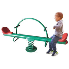 Kids garden seesaw with green base spring and red seats, toddler standing