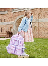 Kids pink backpack with front panel and character keychain, side view