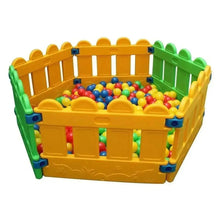 Kids plastic play fence with yellow and green panels, holding a colorful ball pit