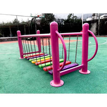 Outdoor playground chain bridge with pink posts and rainbow plank walkway on chains