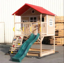Wooden kids playhouse with red roof, window, ladder, and teal slide