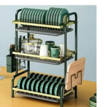 3-tier drying rack holding green plates, cups, and bowls on tiered shelves