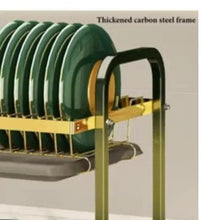 Kitchen dish rack side with stacked plates, gold rails, and utensil holder section
