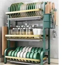 3-tier drain organizer rack with green and white plates, cups, and side utensil hooks