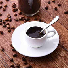 Silver stainless steel dinner spoons set with coffee cup and saucer on wooden table