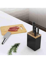 Stainless steel knife rack with black block and wooden knife holders on countertop