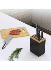 Huitich stainless steel knife rack with multiple knives on kitchen counter next to cutting board with raw meat