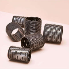 Kitsch black hair rollers set, the best heatless curlers for waves, arranged on a light surface