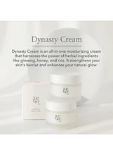 Stacked white facial moisturizer jars with a small box beside them