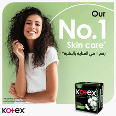 Smiling woman with curly hair beside Kotex Natural Maxi Protect pads UAE box on green No 1 skin care background