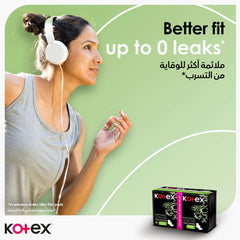 Young woman jogging with headphones next to two Kotex product boxes on green ad background promoting Kotex natural ultra thin pads