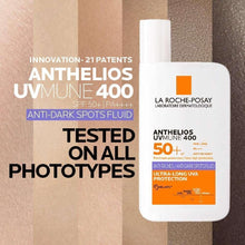 Anthelios UVmune 400 SPF 50+ anti-dark spots fluid bottle on skin swatches.