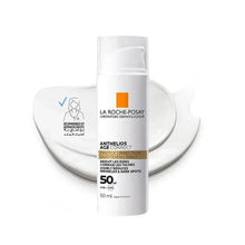 Sunscreen bottle with white cap between heart-shaped white reflectors, orange label
