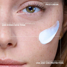 Face sunscreen with white cream on cheek and under-eye area, close-up