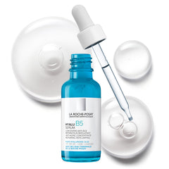 La Roche-Posay Hyalu B5 serum in a blue bottle with dropper, surrounded by clear gel drops for radiant skin
