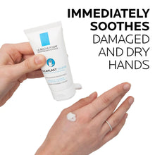 Hand cream tube held above palm with small cream dollop; hands applying