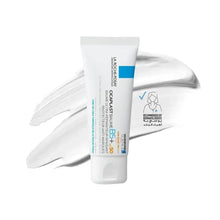 Scar and stretch mark lotion tube with blue label, shown with gloved hands