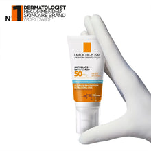 Sunscreen tube SPF 50+ held in a white-gloved hand