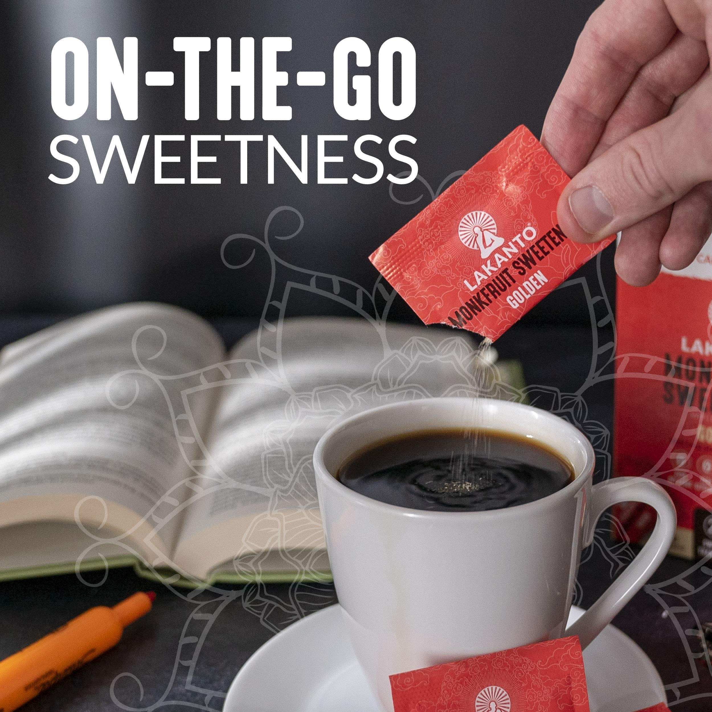Lakanto monkfruit sweetener packets being poured into a cup of black coffee from a red packet near an open book