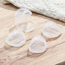 Set of clear heart-shaped pacifier cases with hinged lids, empty for storage.